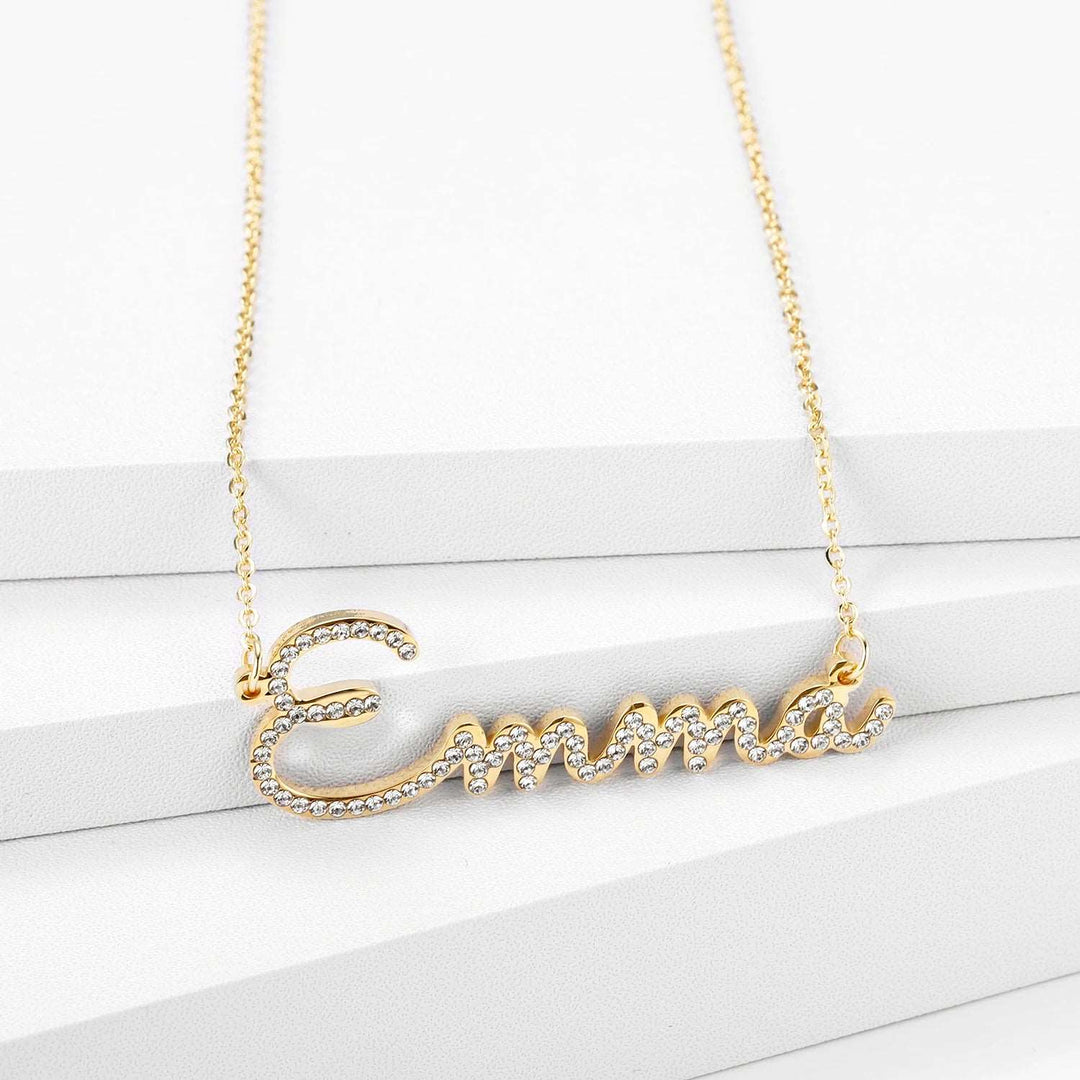 a gold necklace with a name on it