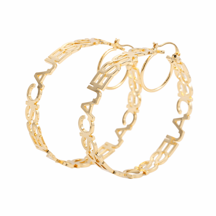 a pair of gold - plated metal bracelets on a white background