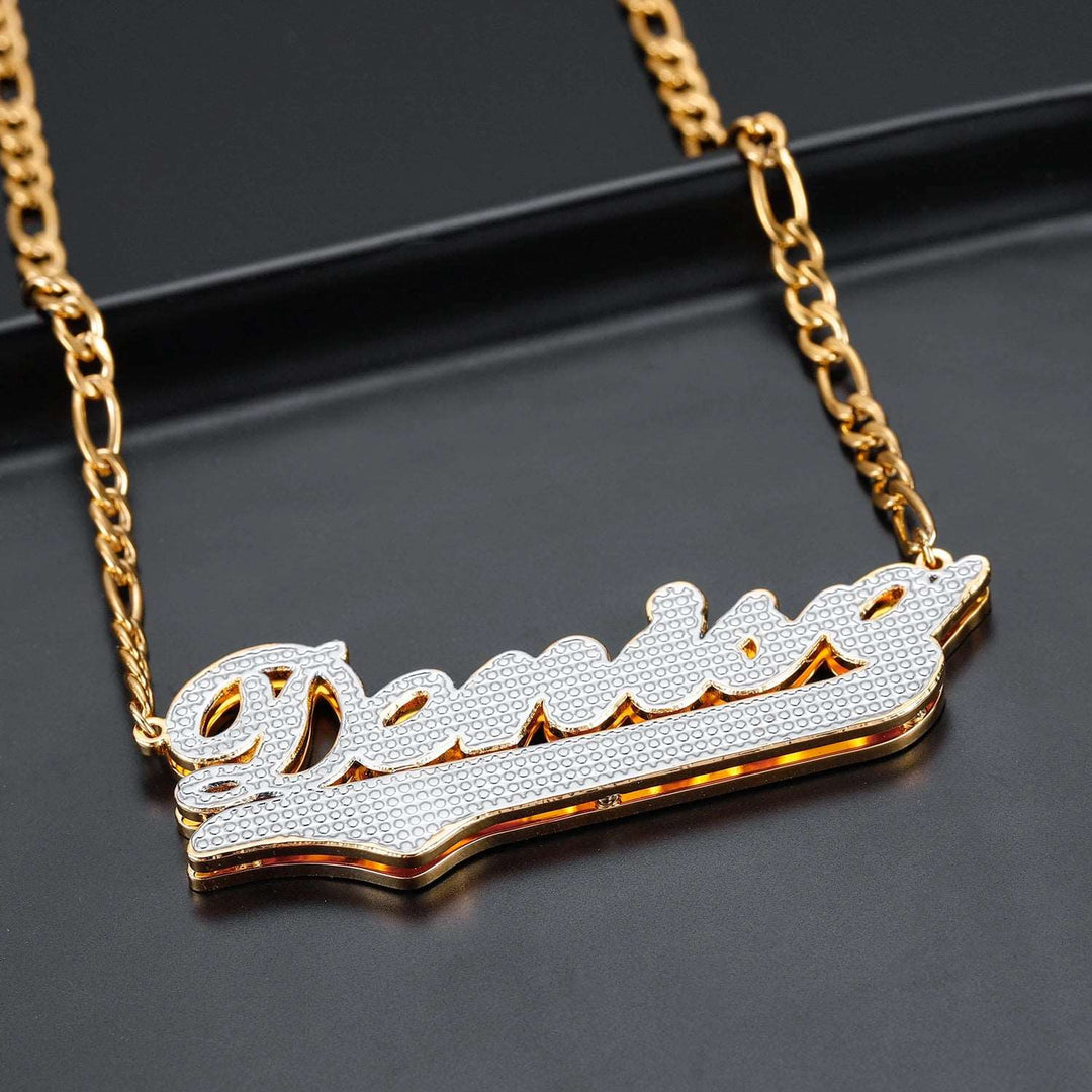 a gold plated necklace with a name on it