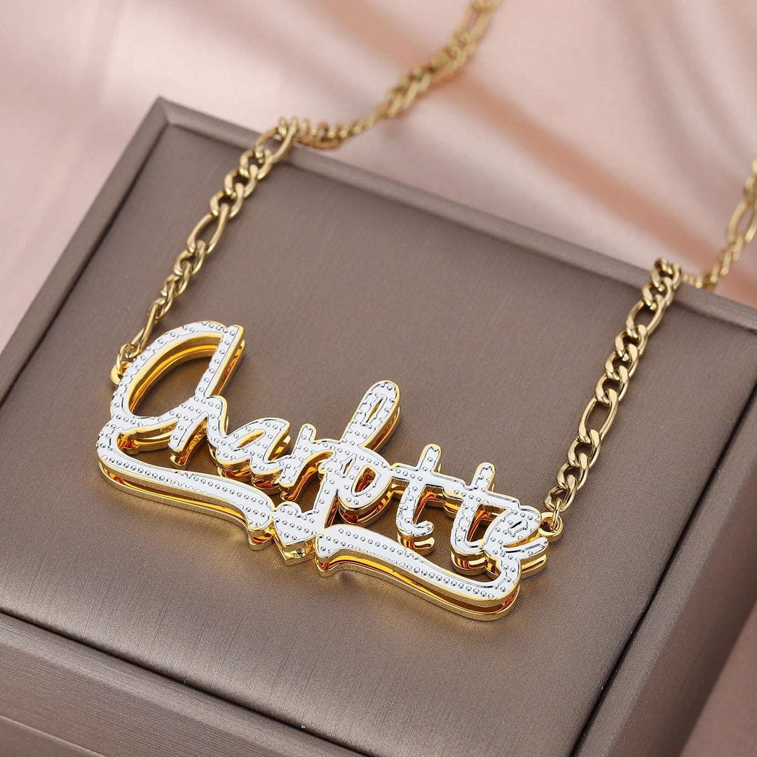 a gold plated necklace with the word charlotte on it