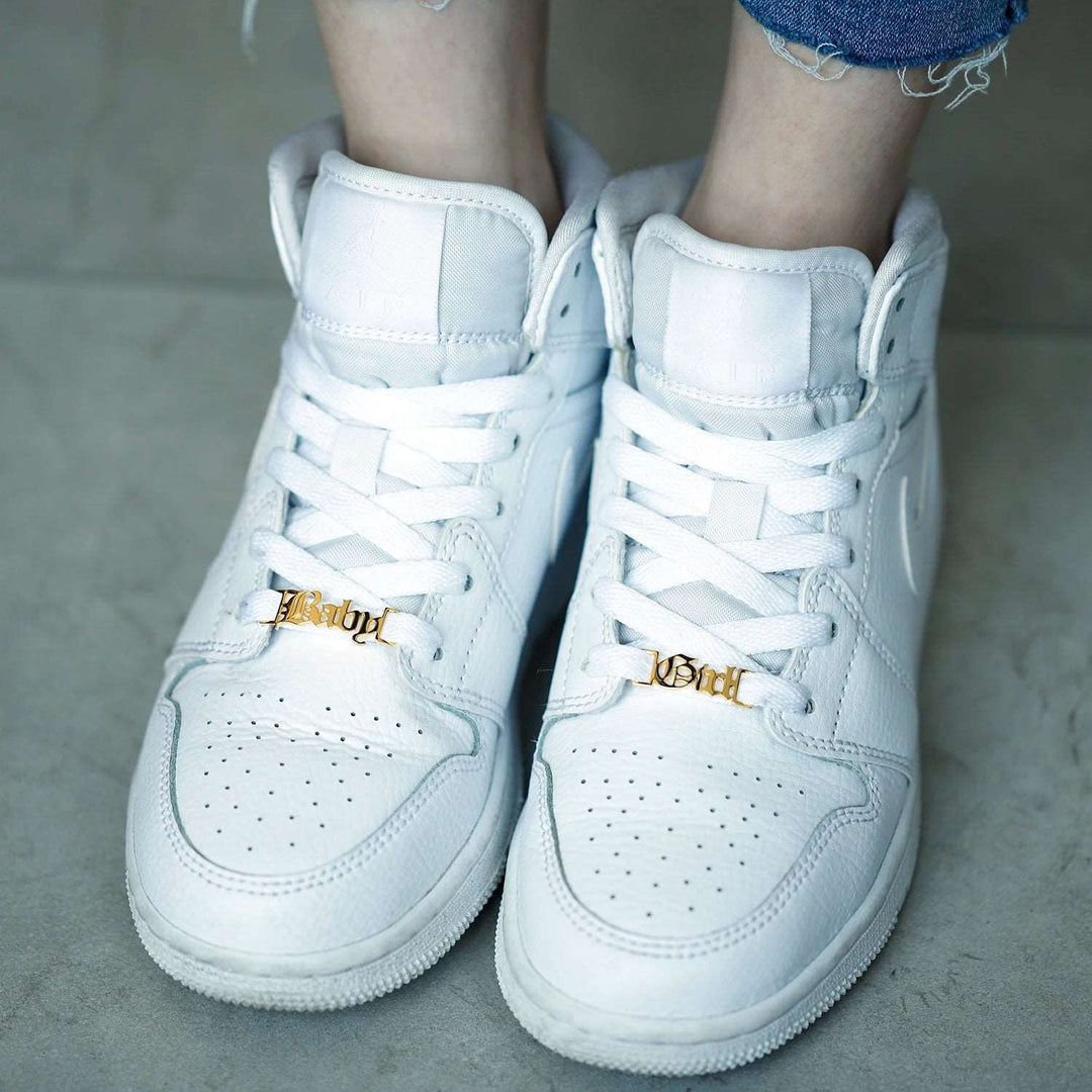 a close up of a person wearing white sneakers