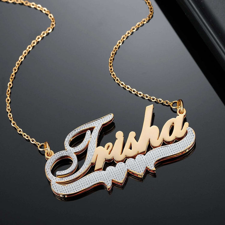 a gold plated necklace with a name on it