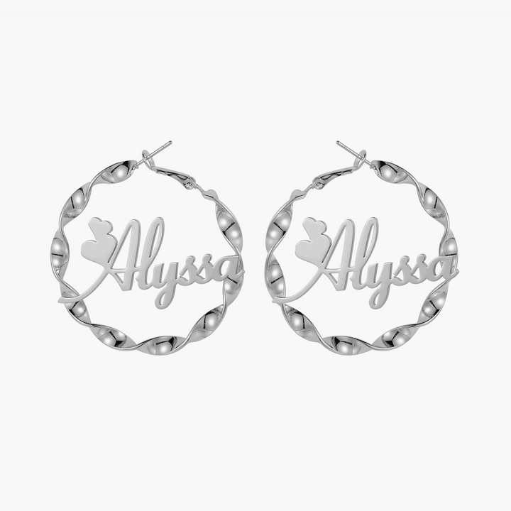 a pair of silver hoop earrings with the word, always