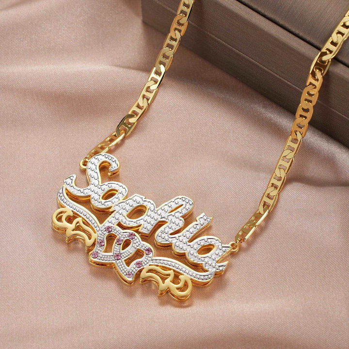 a gold necklace with the word jesus on it