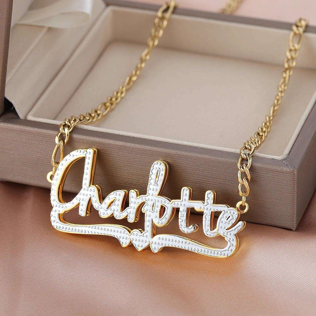 a gold plated necklace with the word charlotte on it