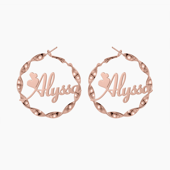 a pair of rose gold hoop earrings with the word always engraved on it