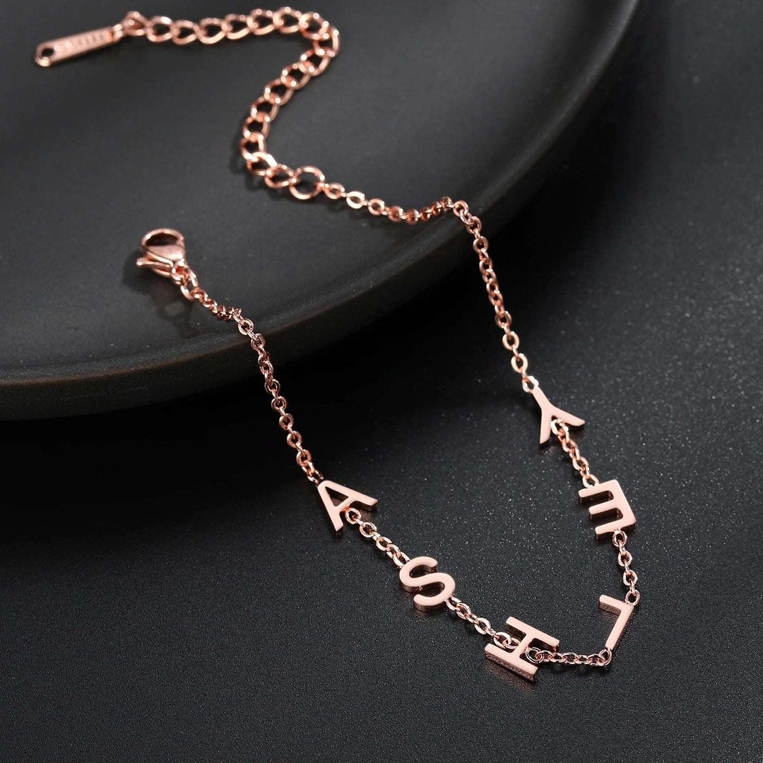 a rose gold necklace with the word love on it