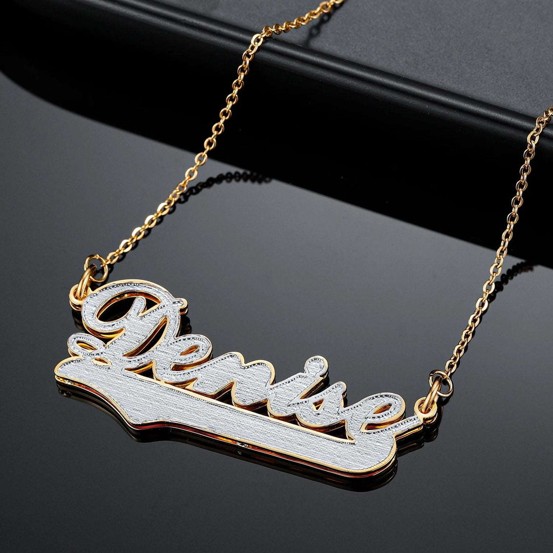 a gold plated name necklace with a name on it