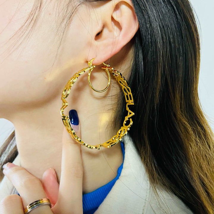 a close up of a person wearing a pair of earrings