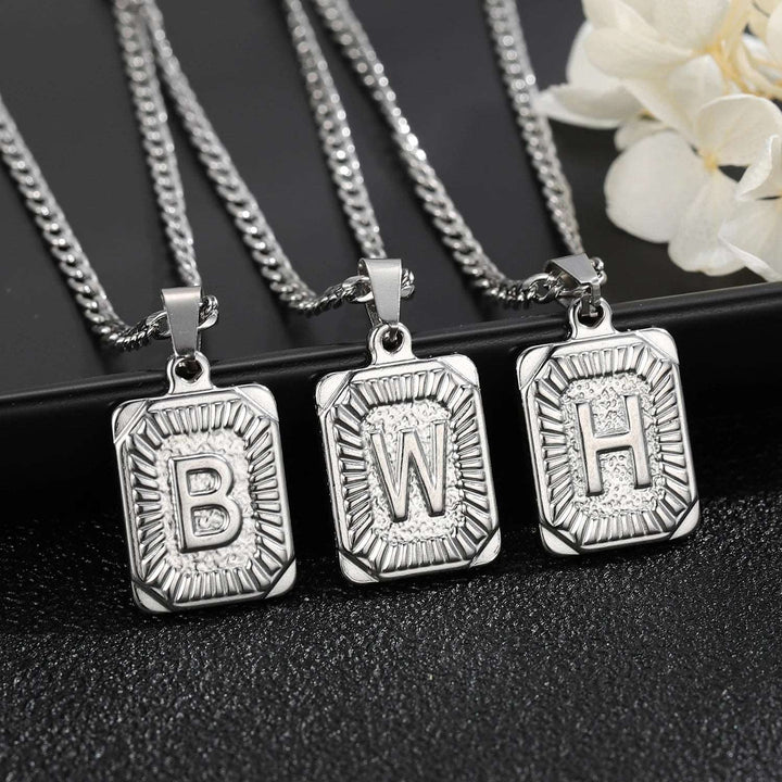 three pendants with the letter b and w on them