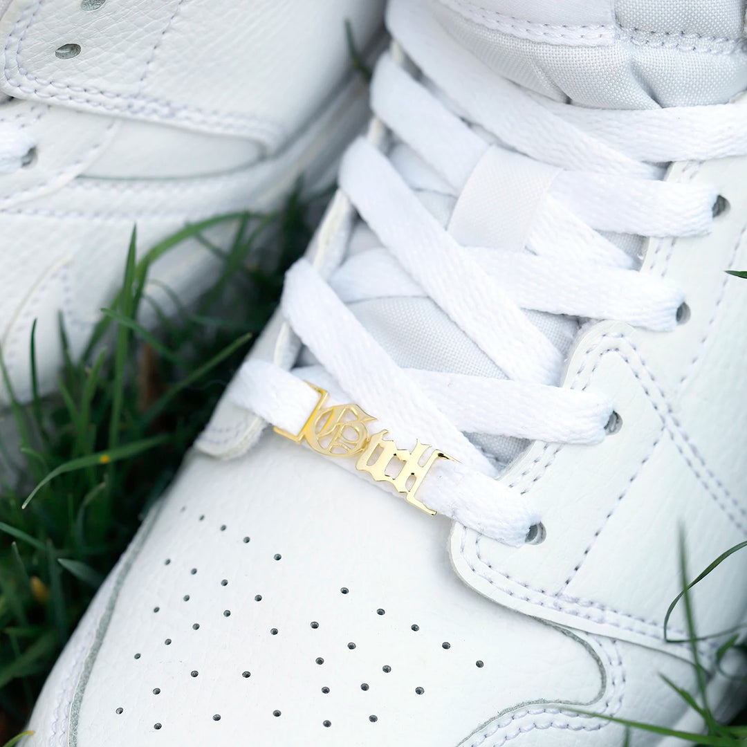 a close up of a pair of white sneakers