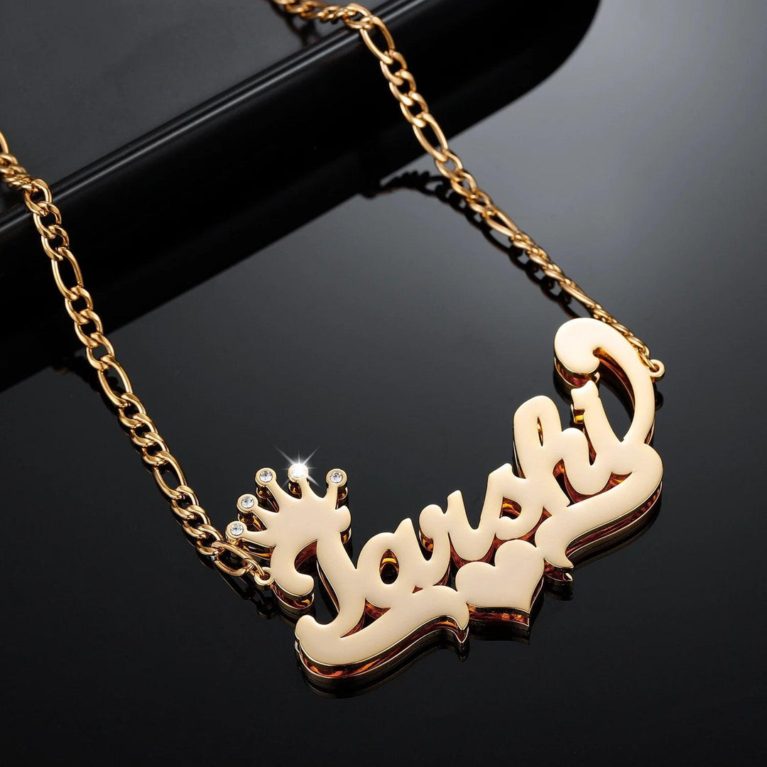 a gold necklace with a name and a crown on it