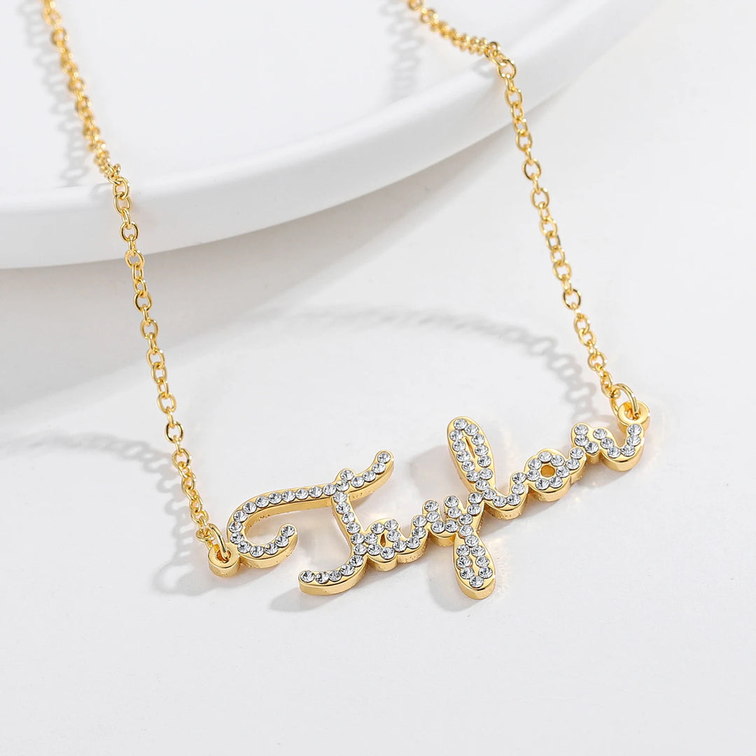 a gold necklace with the word faith on it