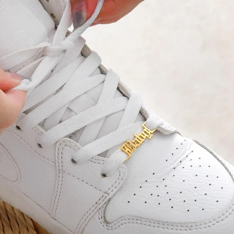 a person tying a shoelace on a white sneaker