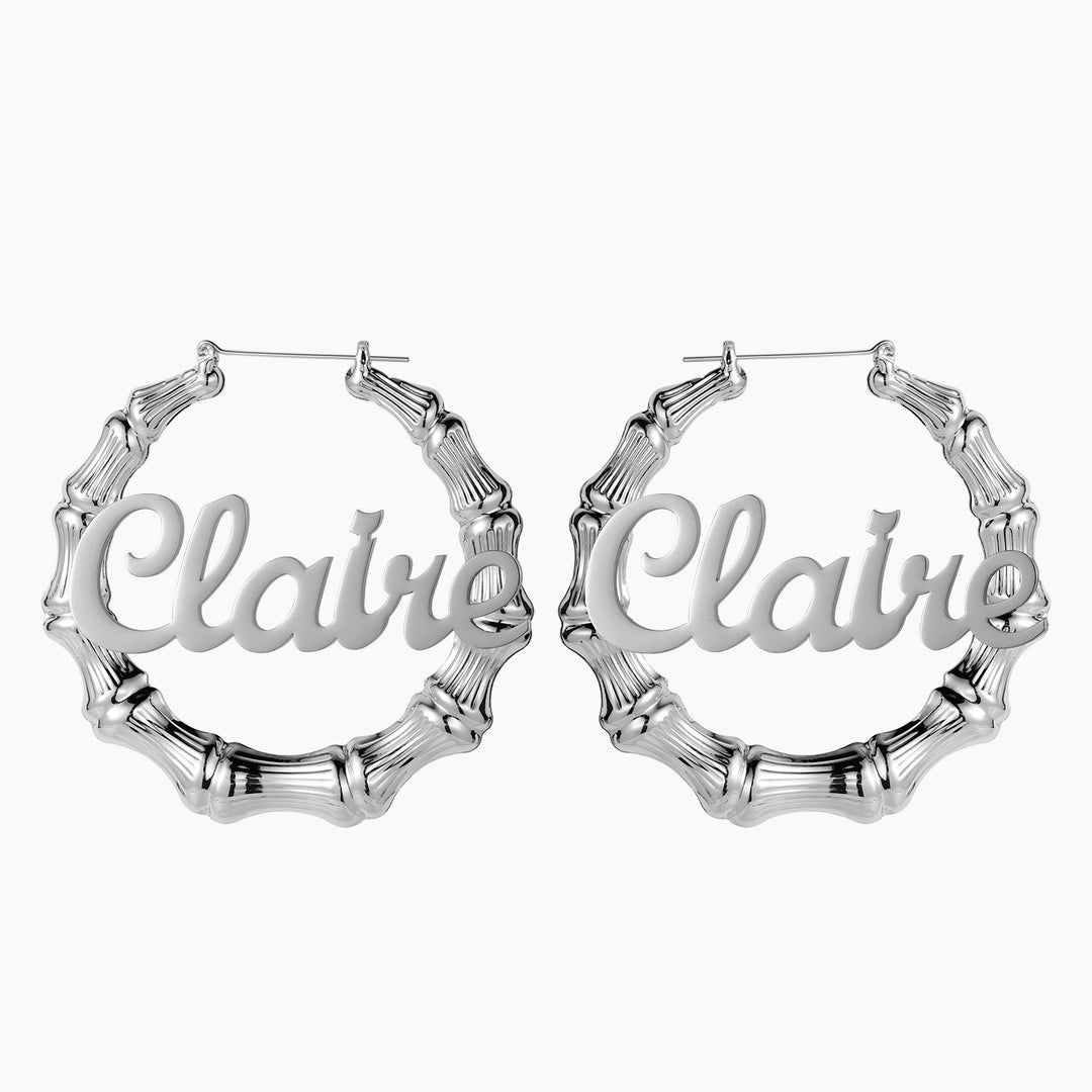 a pair of earrings with the word clair on it