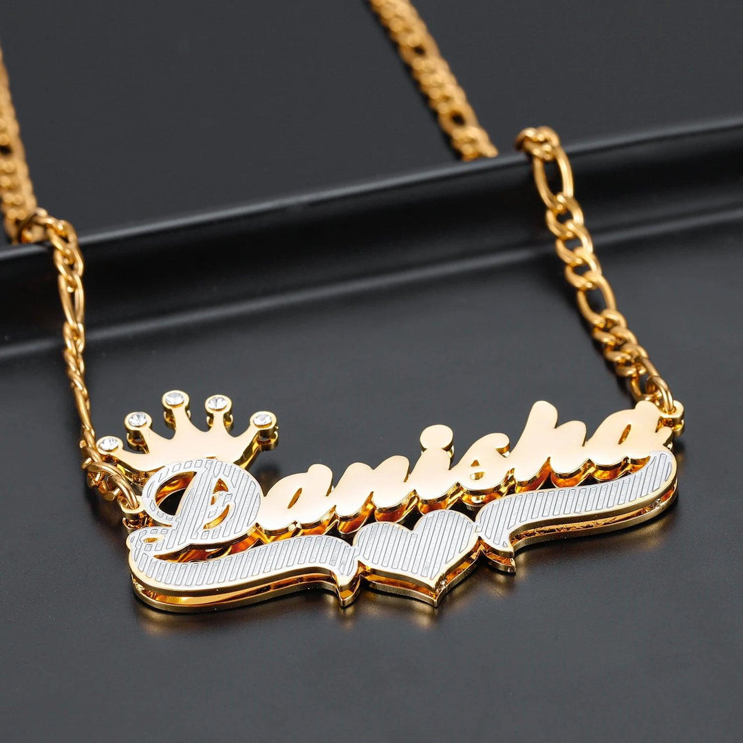 a name necklace with a crown on top of it