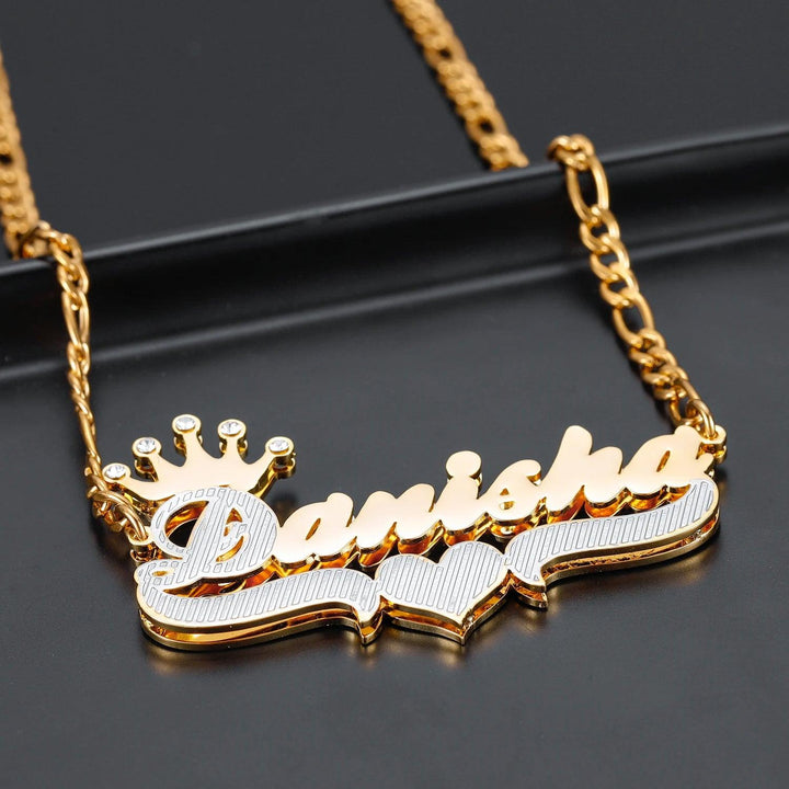 a name necklace with a crown on top of it