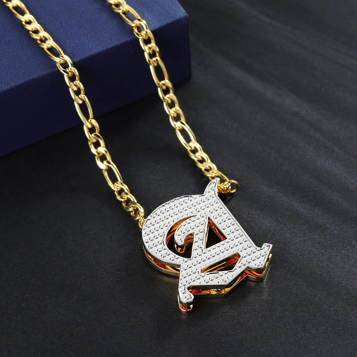 a gold chain with a pendant with the letter a on it