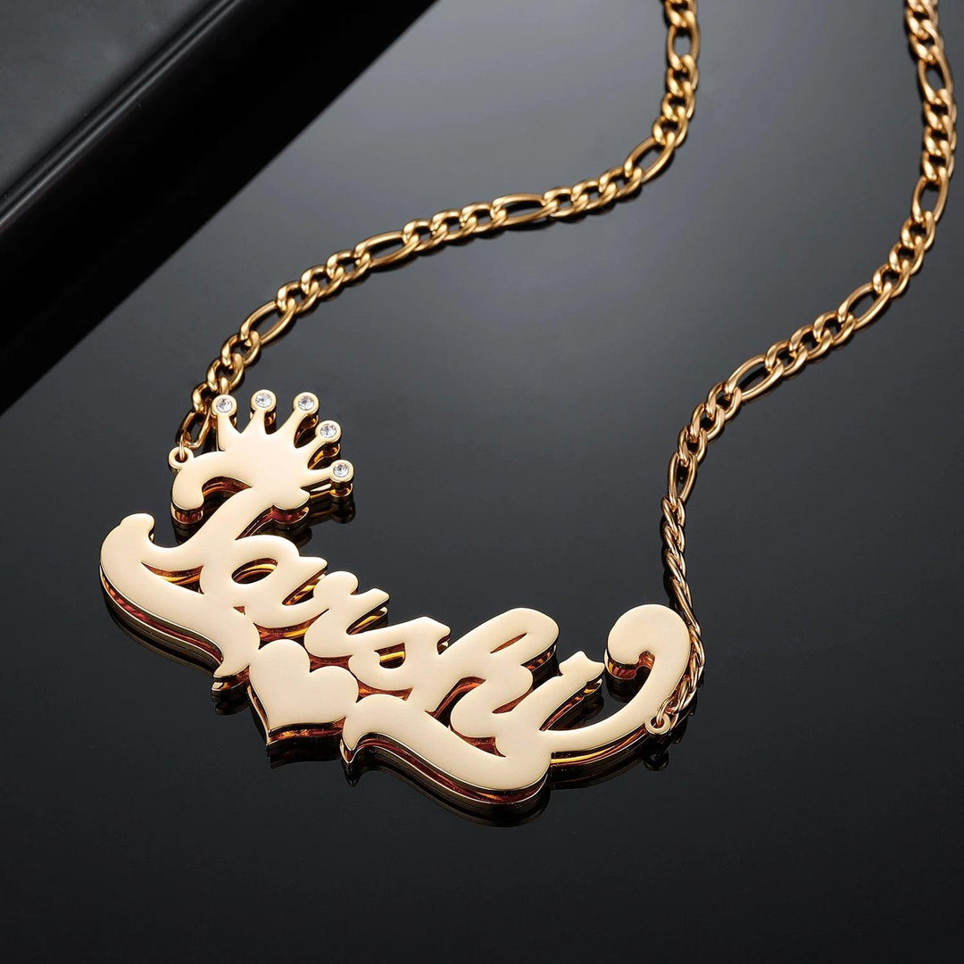 a gold necklace with a crown on it