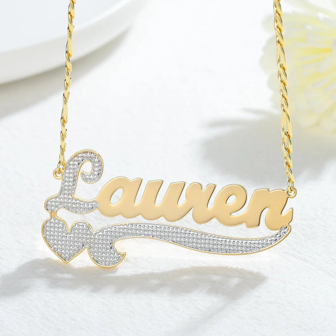 a gold necklace with a name and a bow