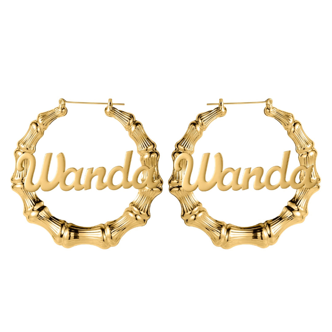 a pair of gold bamboo hoop earrings with the word wandd on it