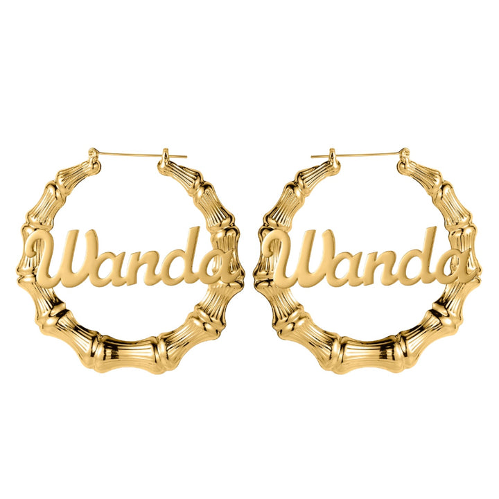 a pair of gold bamboo hoop earrings with the word wandd on it