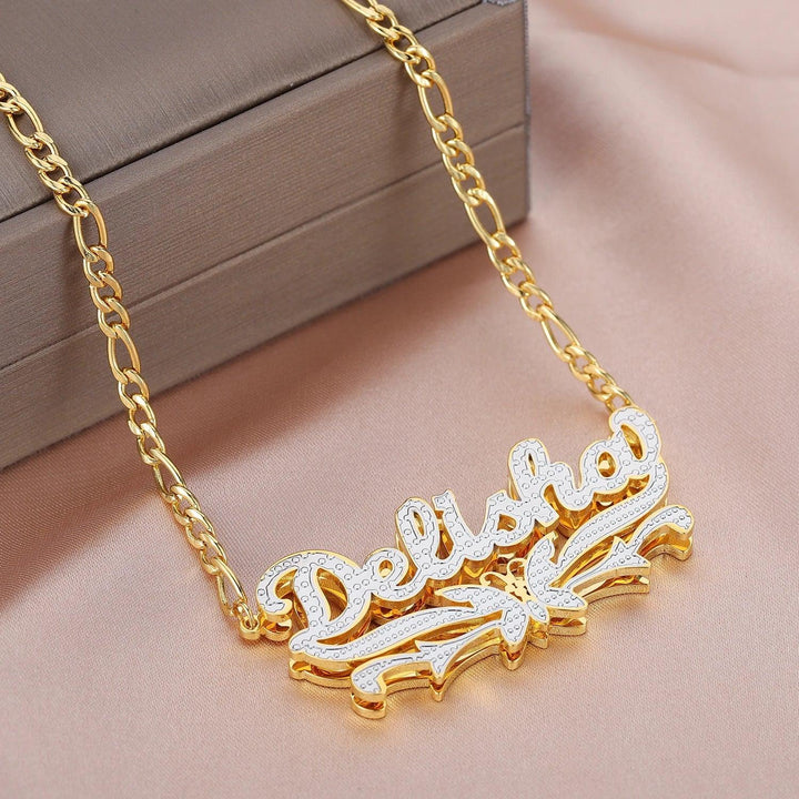 a gold necklace with the word dance on it