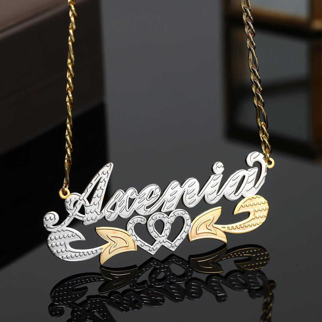 a gold and silver necklace with a name on it