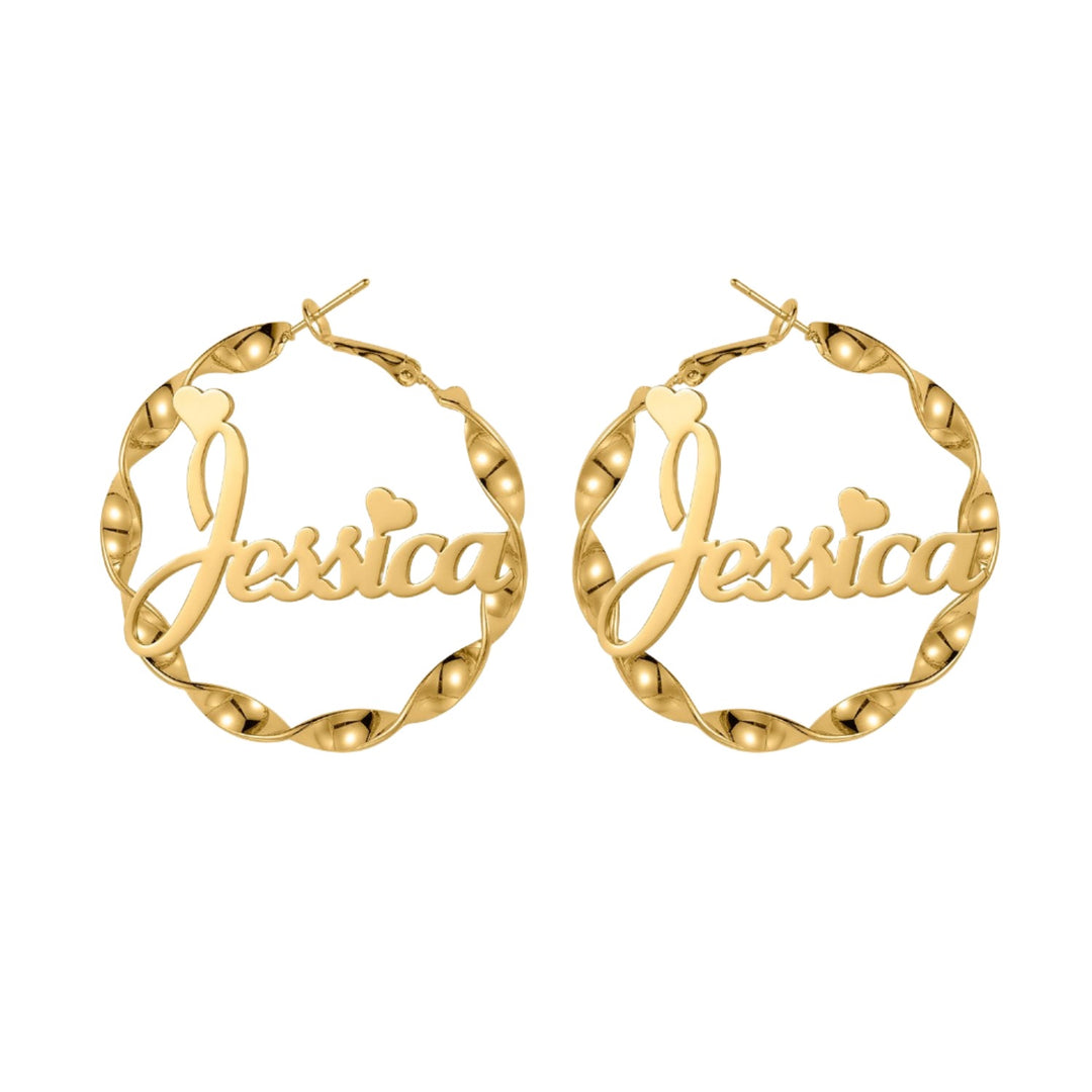 a pair of gold hoop earrings with the word jesus inside of it