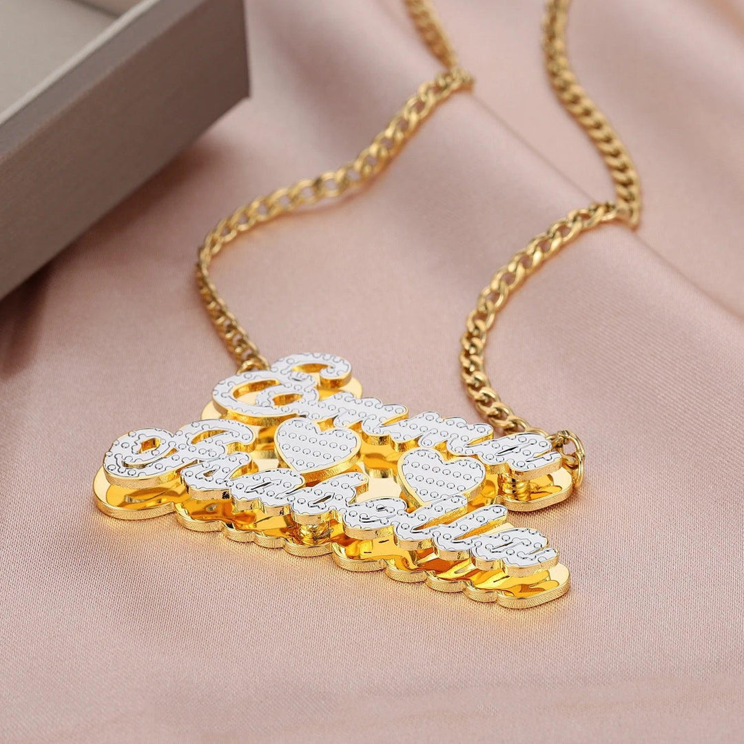 a gold necklace with a flower design on it