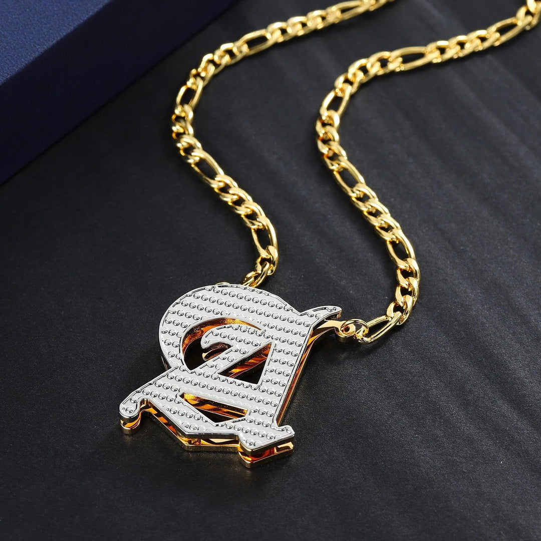 a gold chain with a pendant with a letter on it