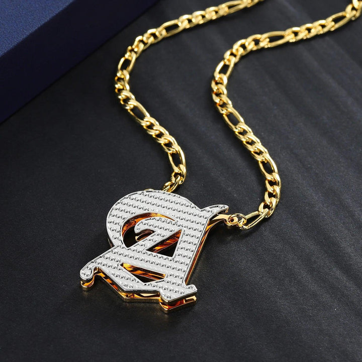 a gold chain with a pendant with a letter on it