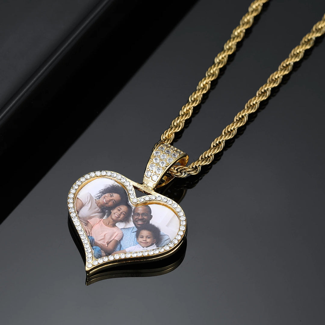 a heart shaped necklace with a picture of a family on it